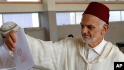 A Moroccan man casts his ballot at a polling station in parliamentary elections, in Rabat, Morocco, Oct. 7, 2016. 