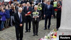 Britain's Prime Minister David Cameron, second from right, stands with Labour Party leader Jeremy Corbyn, left, John Bercow, Speaker of the House of Commons, center, and Labour MP Hilary Benn, second left, as they pay tribute near the scene where Labour Member of Parliament Jo Cox was killed in Birstall, near Leeds, June 17, 2016.