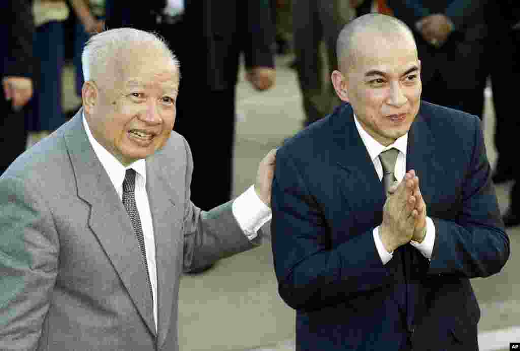 In this October 20, 2004 file photo, Cambodia's King Norodom Sihanouk, left, introduces his son and successor, King Norodom Sihamoni upon their arrival at Phnom Penh airport, in Cambodia. 