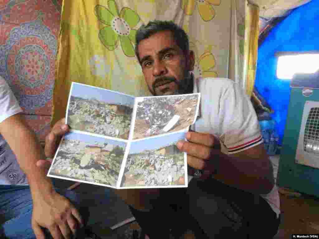 At a refugee camp near Mosul, Ibrahim Makhool holds up pictures of his house that was destroyed in an airstrike against Islamic State militants in December, killing two of his three children, in Hammam Alil, Iraq, June 21, 2017.