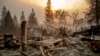 A vintage car rests among debris as the Camp Fire tears through Paradise, Calif., on Nov. 8, 2018. 