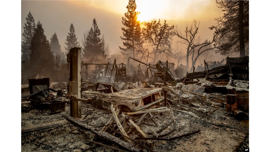 A vintage car rests among debris as the Camp Fire tears through Paradise, Calif., on Nov. 8, 2018.