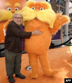 Actor Danny DeVito and the Lorax arrive at the premiere of the animated feature film "The Lorax" in Universal City, California