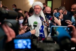 Taliban official Abdul Salam Hanafi, center, speaks to media during an international Russia-hosted meeting on Afghanistan, in Moscow, Russia, Oct. 20, 2021.