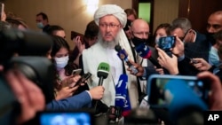 Taliban official Abdul Salam Hanafi, center, speaks to media during an international Russia-hosted meeting on Afghanistan, in Moscow, Russia, Oct. 20, 2021. 