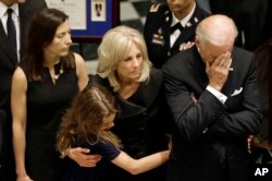 U.S. Vice President Joe Biden, right, rests his head in his hand during a viewing for his son, former Delaware Attorney General Beau Biden, Thursday, June 4, 2015, at Legislative Hall in Dover, Del.