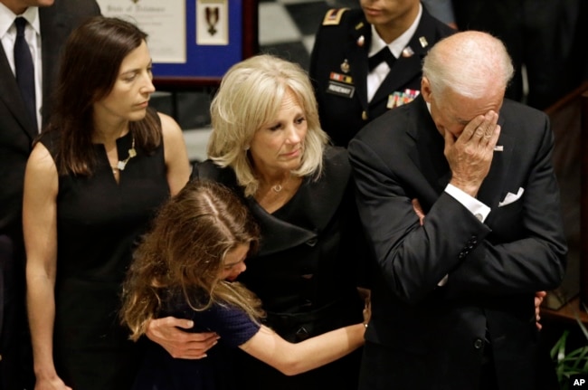 U.S. Vice President Joe Biden, right, rests his head in his hand during a viewing for his son, former Delaware Attorney General Beau Biden, Thursday, June 4, 2015, at Legislative Hall in Dover, Del.