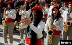 Members of a Palestinian marching band parade during Christmas celebrations at Manger Square outside the Church of the Nativity in Bethlehem, in the Israeli-occupied West Bank, Dec. 24, 2018.