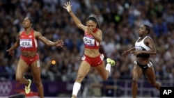United States' Allyson Felix crosses the finish line to win the women's 200-meters final ahead of compatriot Carmelita Jeter, left, and Ivory Coast's Murielle Ahoure, at the 2012 Summer Olympics in London.