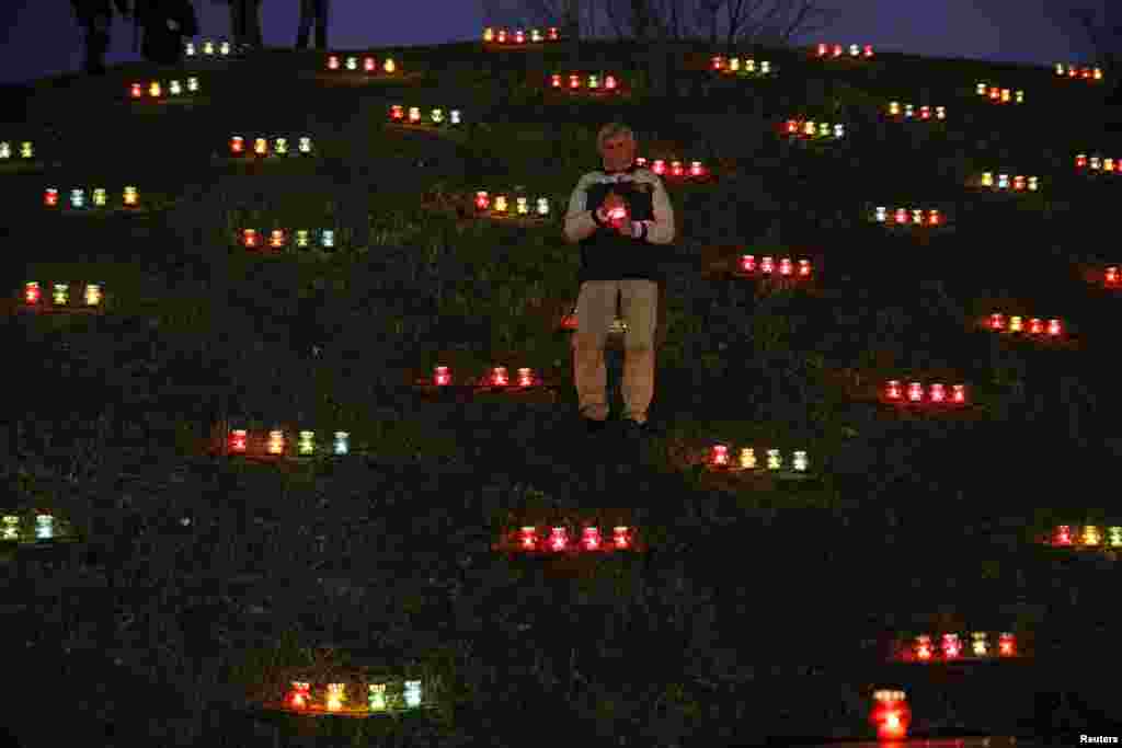 A man attends a commemoration ceremony at a monument for Holodomor victims marking the 82nd anniversary of the famine of 1932-33 in which millions died of hunger in Kyiv, Ukraine, Nov. 28, 2015.