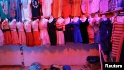 FILE- Short dresses are on display at a local market in Phnom Penh, Cambodia, on June 26, 2013.