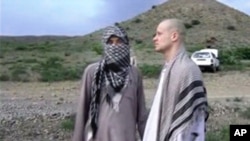 FILE: Qatar has extended travel restrictions for five Taliban men released last year by the United States in exchange for captured U.S. Army Sgt. Bowe Bergdahl, shown at right in undated video image from Voice of Jihad website.