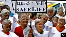 FILE - Elderly women participate in a walk organized to mark the World Elder Abuse Awareness Day in Bangalore, India, June 15, 2011.