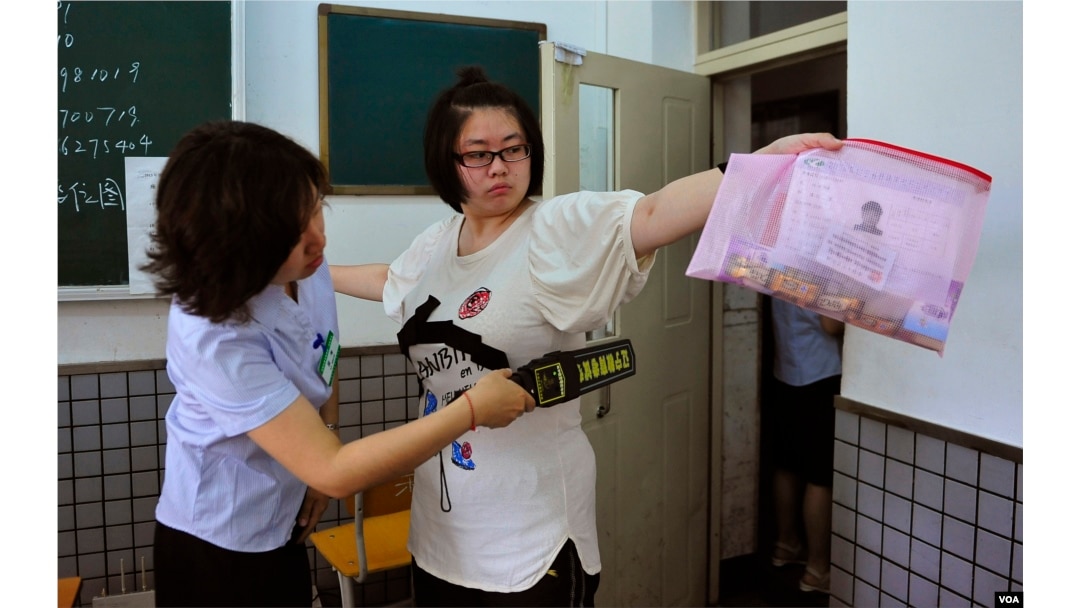 A student goes through a security check as she enters the classroom to take the National College Entrance Exam in Shenyang, Liaoning province in 2013. (REUTERS)