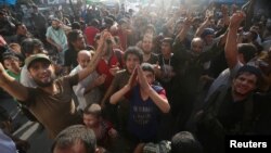 Rebel fighters and people carry the Free Syrian Army and Jabhat Fatah al-Sham flags as they celebrate the news of the breaking of the siege of rebel-held areas of Aleppo, Aug. 6, 2016. 