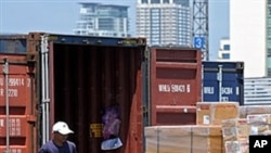 A Thai worker loads boxes into an export container at the Port Authority in Bangkok (File)