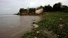 FILE - A Cambodian fisherman takes off his fishing net at Mekong river bank of Koh Norea village in Phnom Penh, Cambodia.
