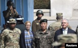 U.S. Secretary of State Rex Tillerson (right) stands with South Korean Deputy Commander of the Combined Force Command Gen. Leem Ho-young (second right) as two North Korean soldiers look at the south side at the border village of Panmunjom, March 17, 2017. Also pictured: Command Sgt. Maj. Steven L. Payton (left) of the United Nations Command, Combined Forces Command and United States Forces Korea and U.S. Secretary of State's Chief of Staff Margaret Peterlin.