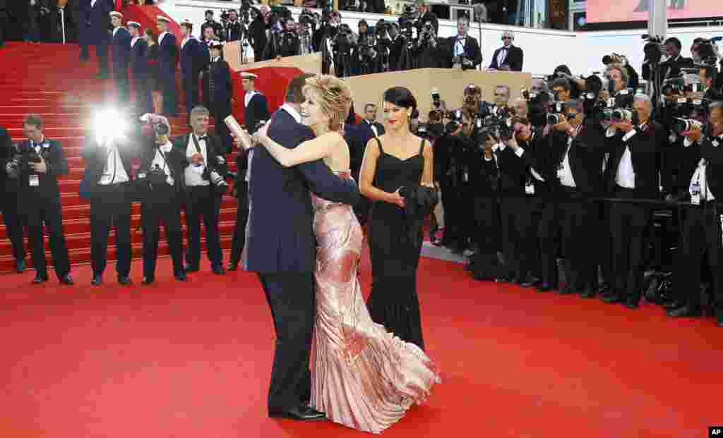 Actress Jane Fonda, center right, embraces actor Alec Baldwin during the opening ceremony and screening of Moonrise Kingdom at the 65th international film festival, in Cannes, southern France, May 16, 2012.