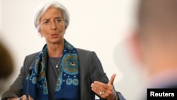IMF Managing Director Christine Lagarde prepares for a news conference at the Treasury in London, June 6, 2014.