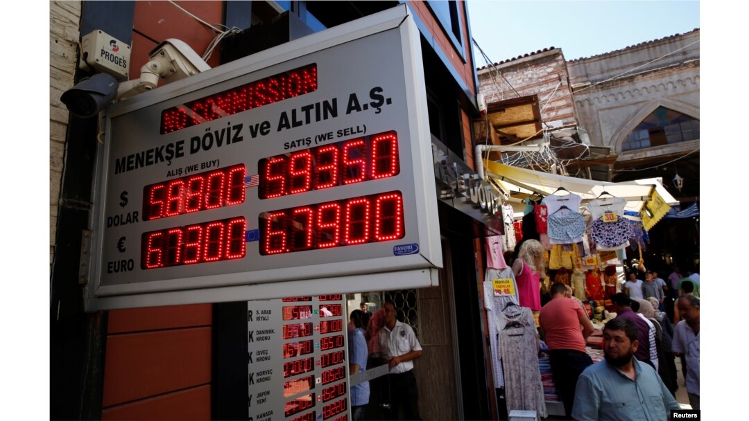 People check currency exchange rates at a currency exchange office in Istanbul, Turkey, Aug. 10, 2018.