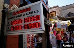 People check currency exchange rates at a currency exchange office in Istanbul, Turkey, Aug. 10, 2018.