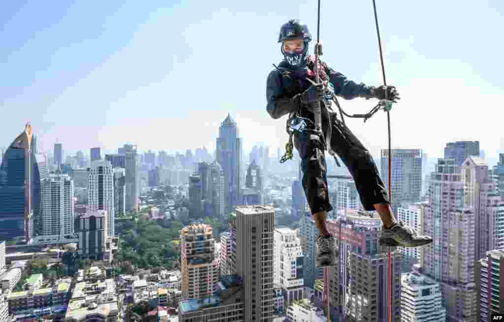 A worker puts up Christmas and New Year lights in Bangkok, Thailand.