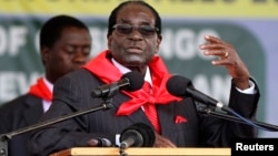 FILE: Zimbabwe President Robert Mugabe addresses people gathered for his 91st birthday celebration in Victoria Falls, Feb. 28, 2015. 