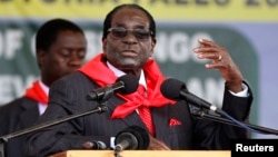 FILE: Zimbabwe President Robert Mugabe addresses people gathered for his 91st birthday celebration in Victoria Falls, Feb. 28, 2015. 