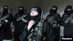 Um Jaafar, a woman fighter in the Free Syrian Army, with other women undergoing military training in Aleppo.