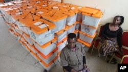 FILE - Polling station workers are seen guarding ballot boxes following presidential elections in Lusaka, Zambia, Jan. 21, 2015.