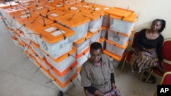 FILE - Polling station workers are seen guarding ballot boxes following presidential elections in Lusaka, Zambia, Jan. 21, 2015.