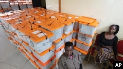 FILE - Polling station workers are seen guarding ballot boxes following presidential elections in Lusaka, Zambia, Jan. 21, 2015.