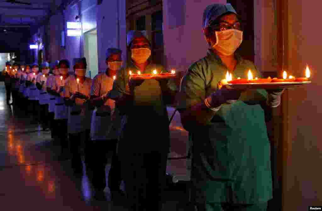 Staff members of a hospital carry candles and oil lamps in Kolkata, India, to show solidarity with people who are affected by the coronavirus disease (COVID-19), and with doctors, nurses and other healthcare workers from all over the world.