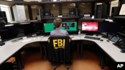 FILE - An FBI employee works in a computer forensics lab at the FBI field office in New Orleans. 