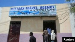 FILE - People enter an internet cafe in the Hodan area of Mogadishu.