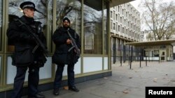 FILE - Police officers are seen patrolling outside the U.S. Embassy in London in a Dec. 9, 2014, photo.