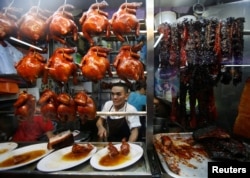 Hawker Chan Hong Meng, who won a Michelin star, sells soya sauce chicken at his Hong Kong Soya Sauce Chicken Rice and Noodle stall at Chinatown food center in Singapore July 22, 2016.