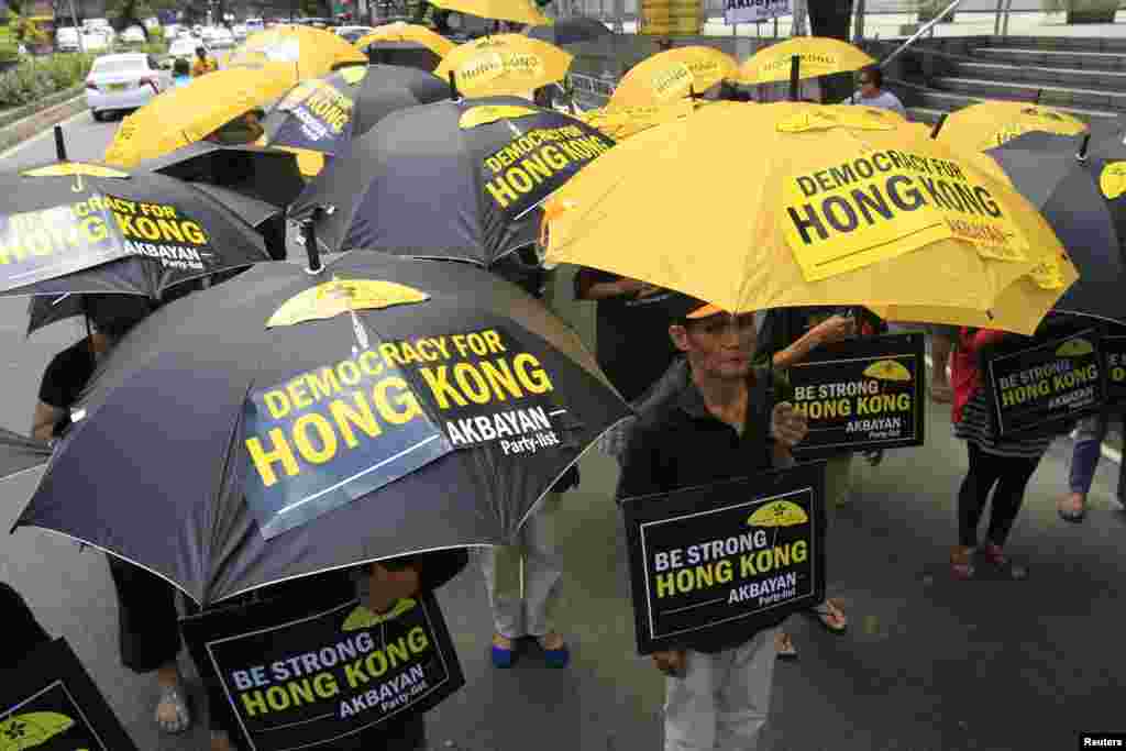 Activists in support of the pro-democracy demonstrations in Hong Kong protest in front of the Chinese Consular office in Makati city, metro Manila, Oct. 2, 2014.