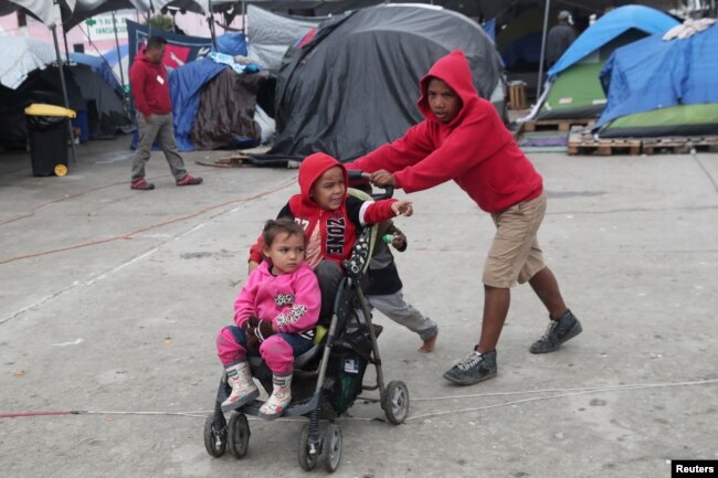 FILE - Migrant children from Nicaragua, part of a caravan of thousands from Central America tying to reach the United States, play at a temporary shelter in Tijuana, Mexico, Jan. 18, 2019.