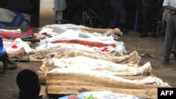 Bodies of victims of armed raiders covered-over with cloth are lined-up for identification on September 19, 2011 in the capital Bujumbura.