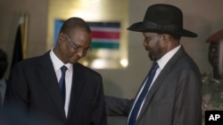 South Sudan's First Vice President Taban Deng Gai, left, speaks with President Salva Kiir after Taban was sworn in, replacing opposition leader Riek Machar, at the presidential palace in Juba, South Sudan, July 26, 2016.