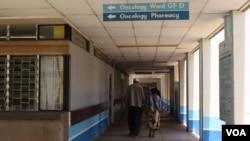 FILE - A patient accompanied by a visitor is seen walking inside Kenyatta National Hospital in Nairobi, Kenya. According to the country’s Ministry of Health, every year about 41,000 new cases are diagnosed in Kenya every year. (VOA / R. Ombuor)