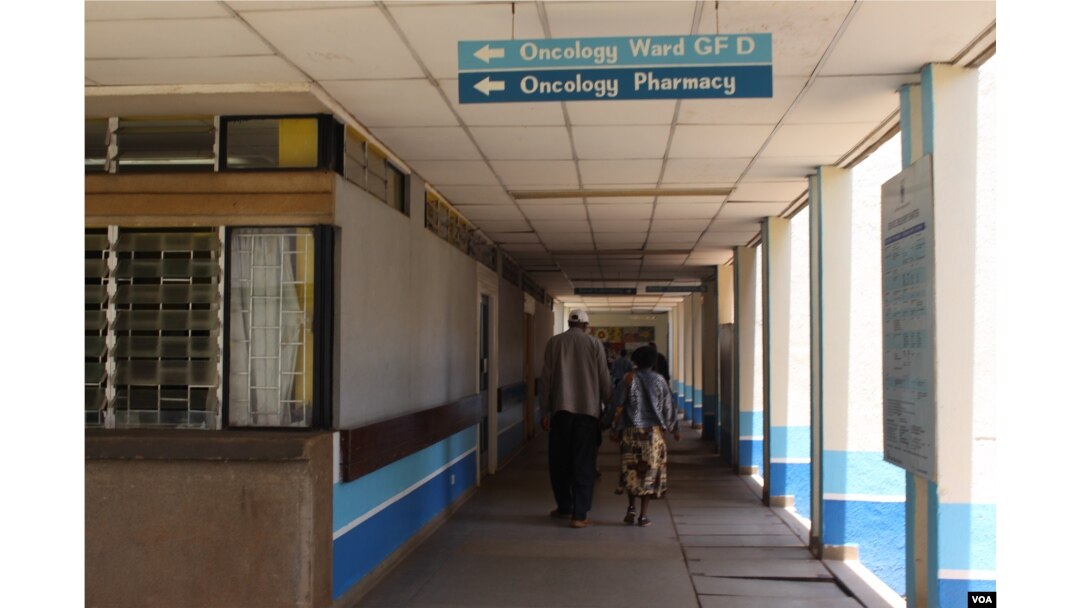 FILE - A patient accompanied by a visitor is seen walking inside Kenyatta National Hospital in Nairobi, Kenya.