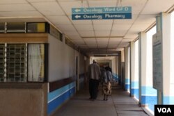 FILE - A patient accompanied by a visitor is seen walking inside Kenyatta National Hospital in Nairobi, Kenya.