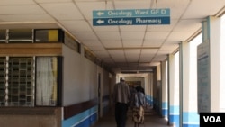 FILE - A patient accompanied by a visitor is seen walking inside Kenyatta National Hospital in Nairobi, Kenya. According to the country’s Ministry of Health, every year about 41,000 cancer cases are diagnosed in Kenya. Most of Kenyans who seek treatment cannot afford private care. (R. Ombuor/VOA)