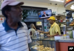 A customer watches a televised statement by Brazil's President Michel Temer at a snack bar in Rio de Janeiro, Brazil, June 27, 2017.