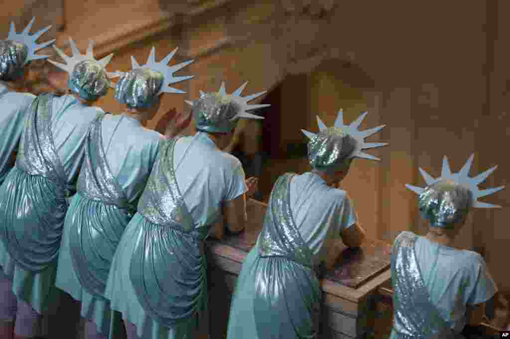 Dancers of a carnival club, dressed as Statue of Liberty, watch performances of other clubs in the Saxony governor&#39;s office in Dresden, eastern Germany.