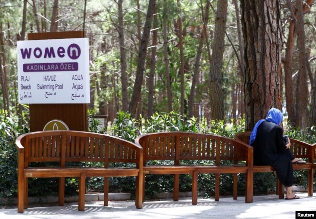 Seorang tamu duduk di dekat tanda yang menunjukkan tempat untuk perempuan di Wome Deluxe Hotel, resor liburan yang ramah dan halal, di Alanya, Turki, 18 April 2018. (REUTERS/Osman Orsal)