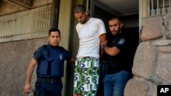 FILE - Police arrest a man in connection with a double-murder, in Mendoza, Argentina, Jan. 26, 2019.